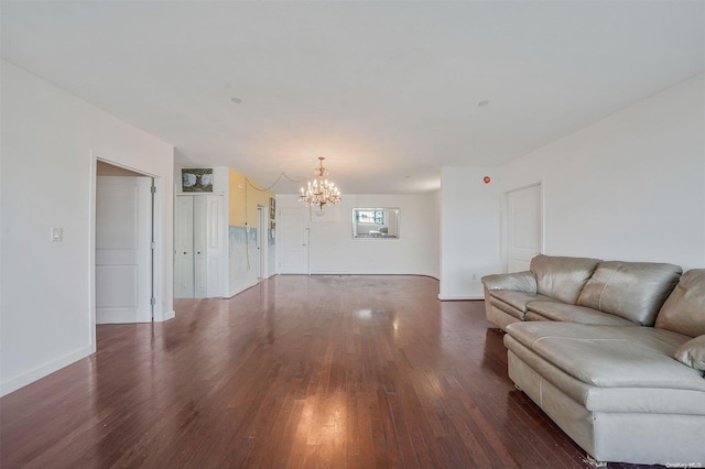 unfurnished living room featuring dark hardwood / wood-style floors and a notable chandelier