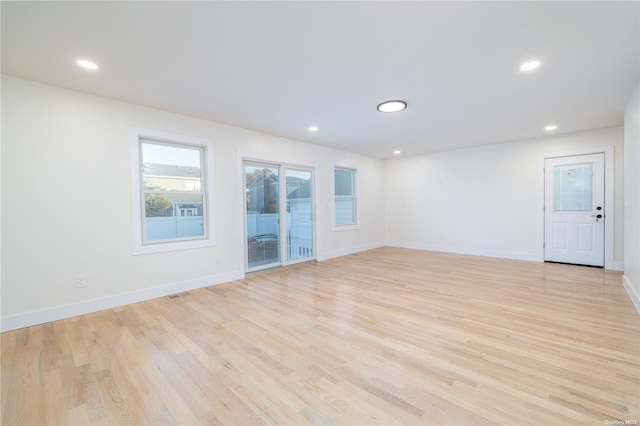 spare room with light hardwood / wood-style floors