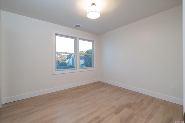 empty room with light hardwood / wood-style flooring