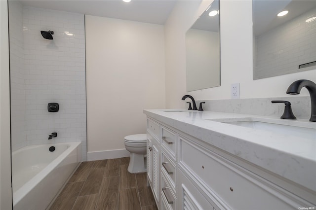 full bathroom with vanity, toilet, and tiled shower / bath combo