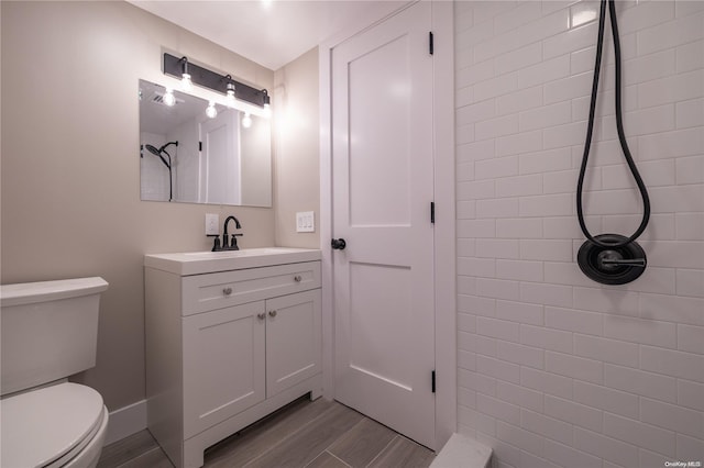 bathroom featuring vanity, hardwood / wood-style flooring, and toilet