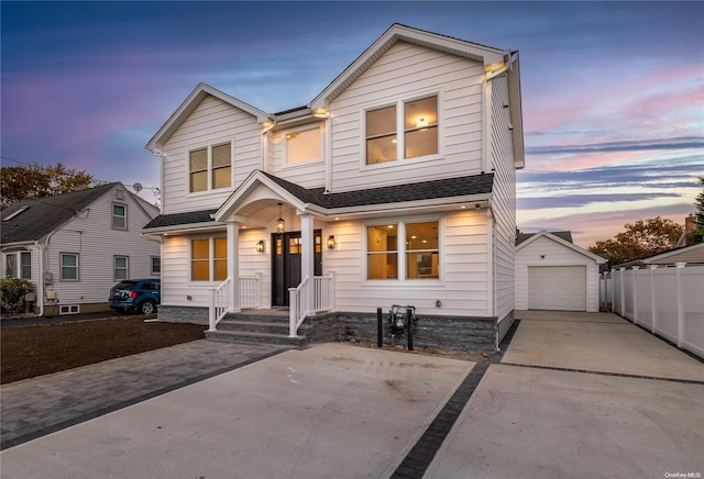 view of front of property featuring a garage and an outdoor structure