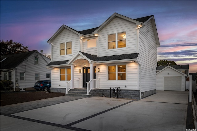 view of front of house with a garage and an outdoor structure