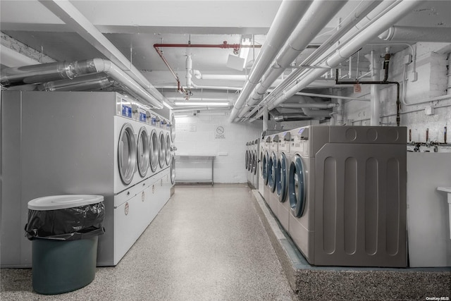 clothes washing area with washing machine and dryer