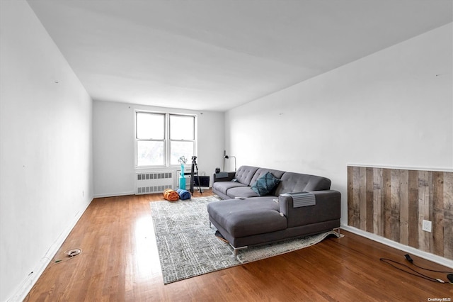 living room featuring wood-type flooring and radiator heating unit