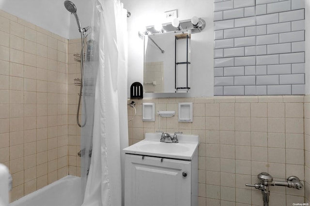 bathroom with decorative backsplash, shower / tub combo, vanity, and tile walls