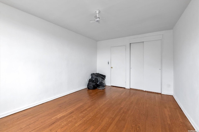 unfurnished bedroom featuring a closet and hardwood / wood-style floors