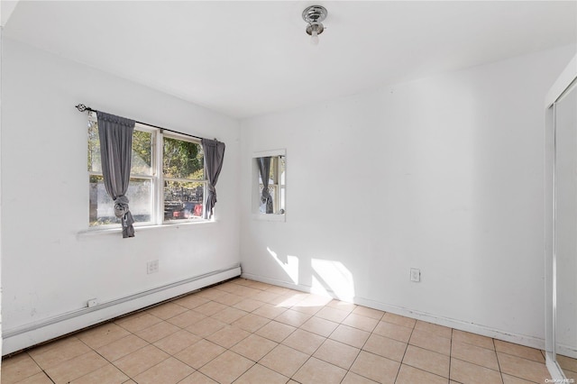 unfurnished room featuring light tile patterned floors and a baseboard radiator