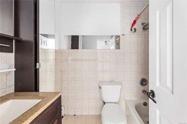 full bathroom with tile patterned floors, vanity, tile walls, and toilet