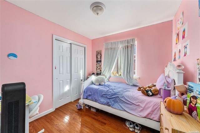 bedroom with a closet and hardwood / wood-style floors