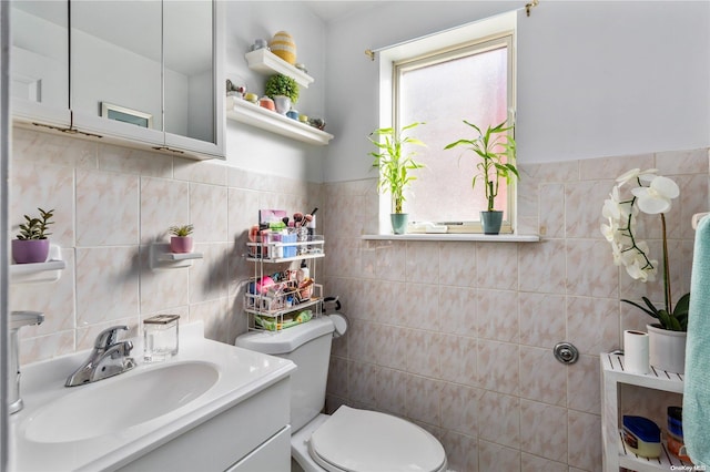 bathroom with backsplash, vanity, toilet, and tile walls