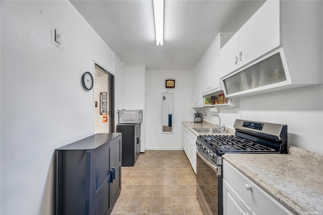 kitchen with sink, white cabinets, and stainless steel gas range