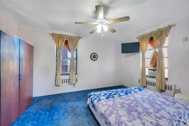 carpeted bedroom featuring ceiling fan, cooling unit, radiator, and multiple windows