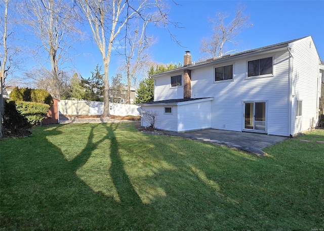 back of property featuring a lawn and a patio