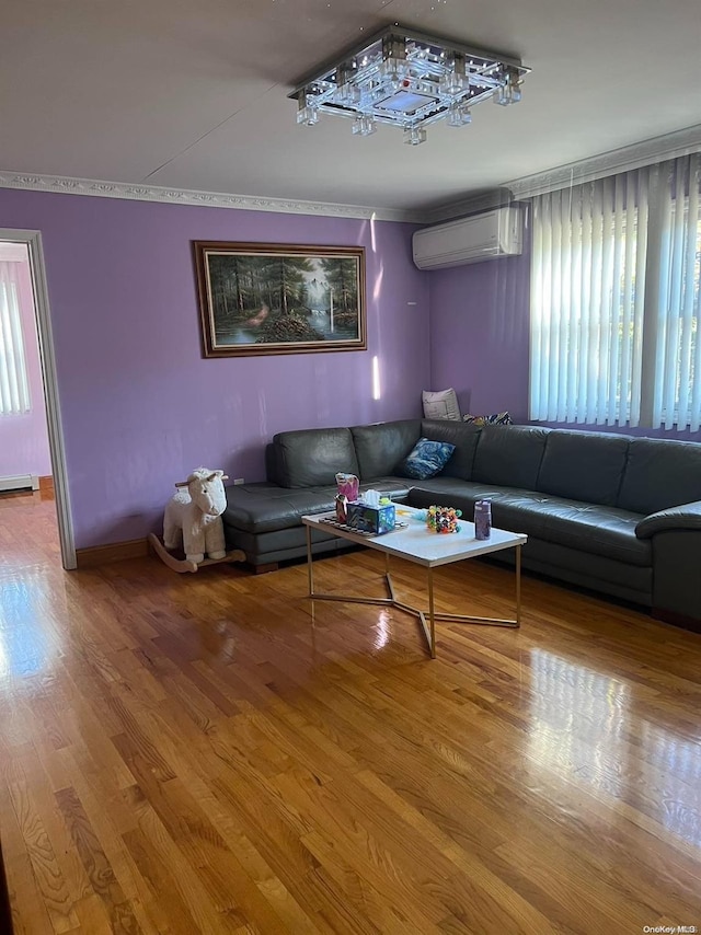 living room with hardwood / wood-style flooring, plenty of natural light, and a wall mounted AC