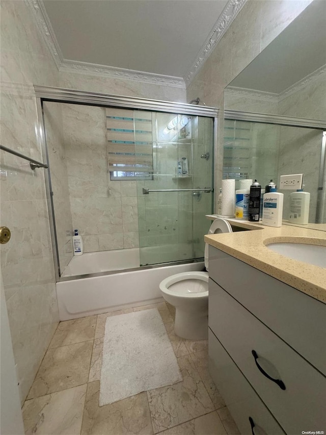 full bathroom with vanity, toilet, ornamental molding, and enclosed tub / shower combo