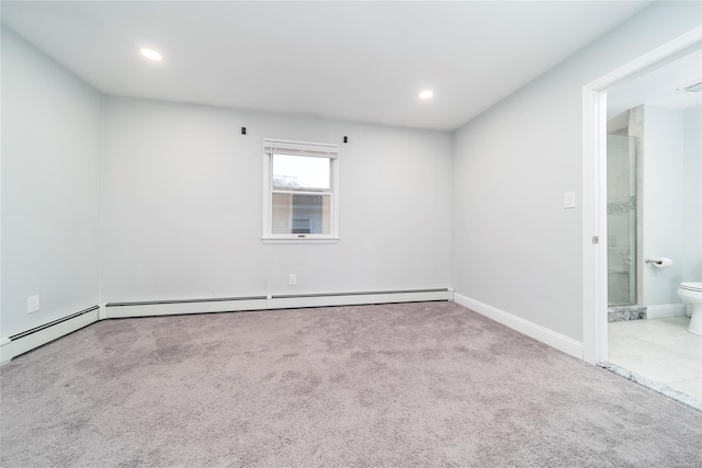 carpeted spare room with a baseboard radiator