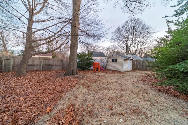 view of yard featuring a playground and a storage shed