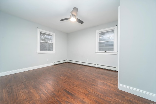 empty room featuring a baseboard heating unit, ceiling fan, and dark hardwood / wood-style floors