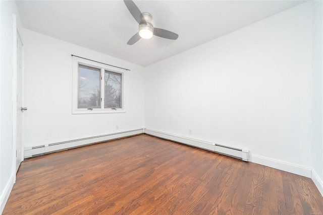 spare room featuring ceiling fan, a baseboard heating unit, and dark hardwood / wood-style flooring