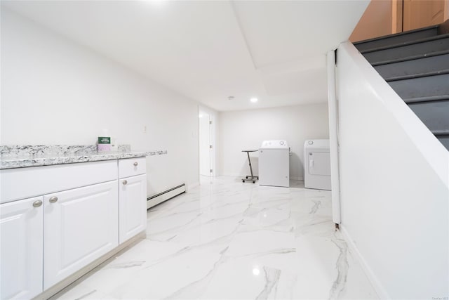 laundry area with baseboard heating and washer and dryer