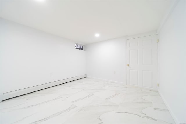 spare room featuring a baseboard heating unit