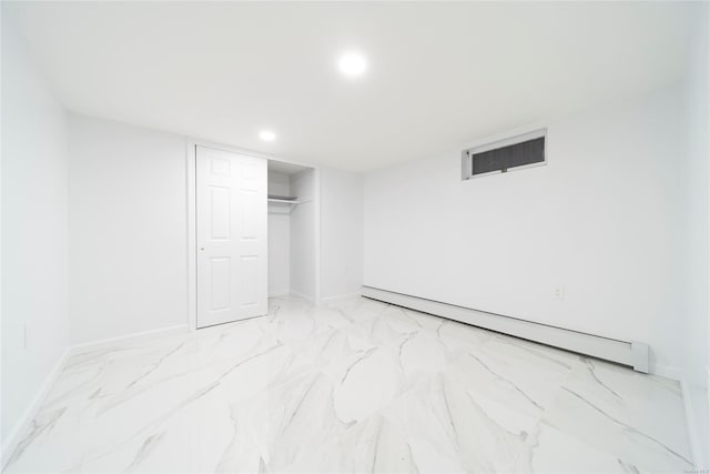 unfurnished bedroom featuring a baseboard radiator and a closet