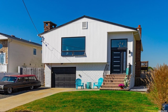 view of front facade with a front yard and a garage