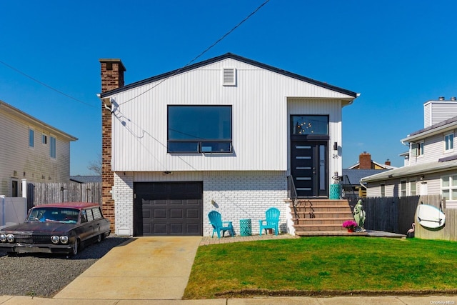 view of front of house with a front lawn and a garage