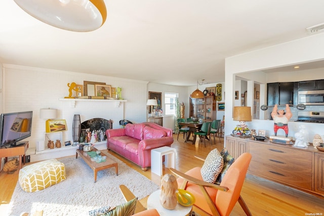 living room featuring a fireplace and light hardwood / wood-style flooring