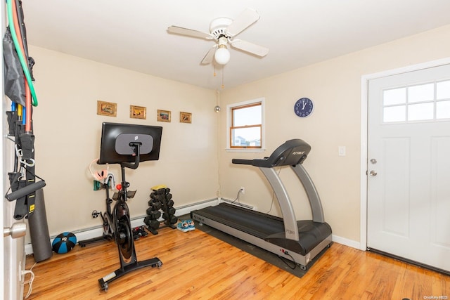 exercise room with ceiling fan and light hardwood / wood-style flooring