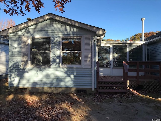 view of home's exterior featuring a wooden deck