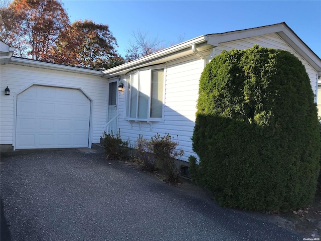 view of side of home with a garage