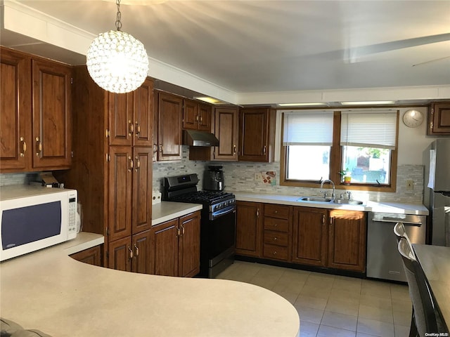 kitchen with stainless steel appliances, sink, decorative light fixtures, a chandelier, and light tile patterned flooring