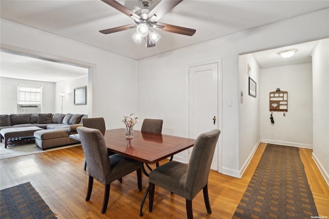 dining area with ceiling fan, light hardwood / wood-style floors, and ornamental molding