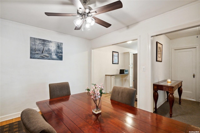 dining room featuring ceiling fan and crown molding