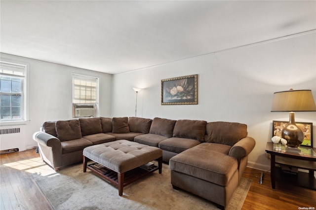 living room featuring light wood-type flooring, radiator, and cooling unit