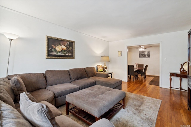 living room with hardwood / wood-style flooring and ceiling fan