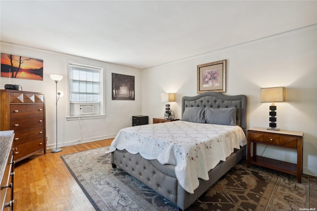 bedroom with hardwood / wood-style floors and cooling unit