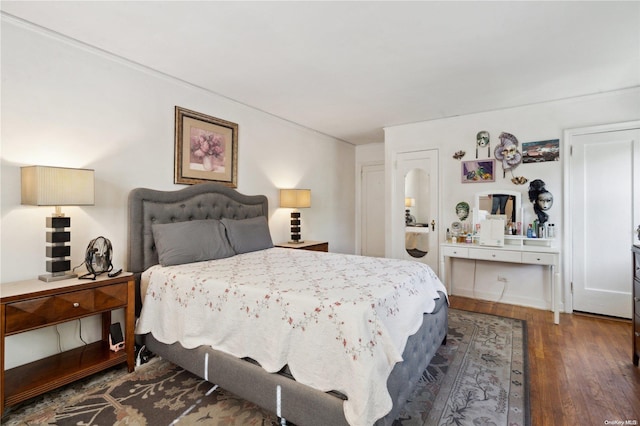 bedroom with dark hardwood / wood-style floors