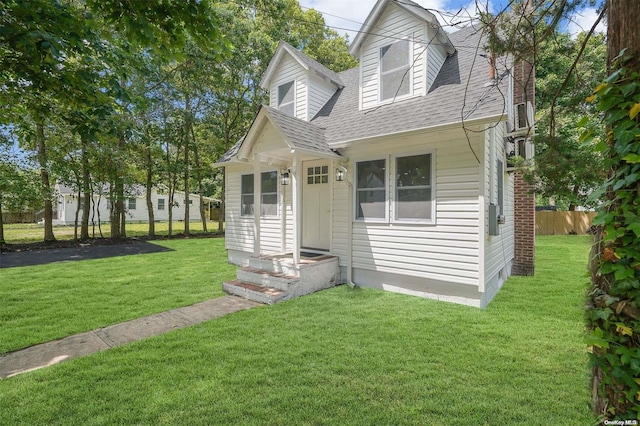 cape cod-style house with a front yard