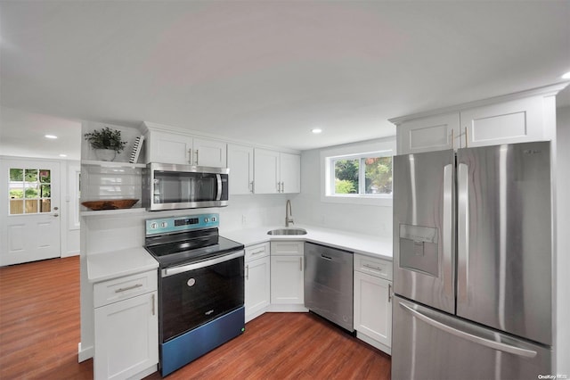 kitchen with white cabinets, sink, stainless steel appliances, and dark wood-type flooring