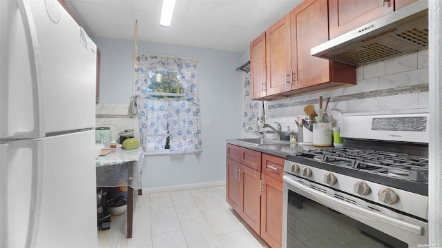 kitchen featuring decorative backsplash, gas stove, sink, exhaust hood, and white refrigerator