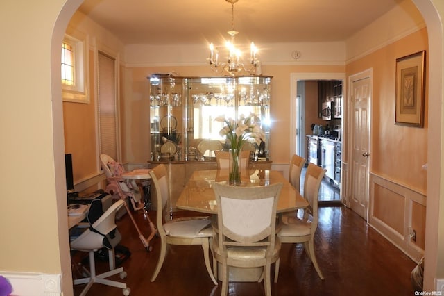 dining space featuring ornamental molding, dark hardwood / wood-style floors, beverage cooler, and a notable chandelier