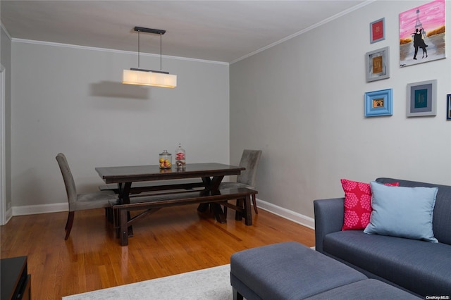 dining room featuring wood-type flooring and crown molding