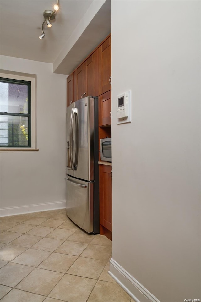 kitchen featuring light tile patterned floors and stainless steel appliances