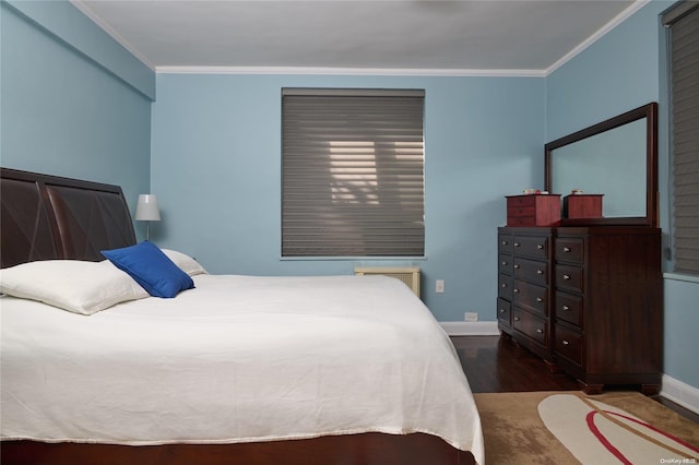 bedroom featuring ornamental molding, dark wood-type flooring, and radiator