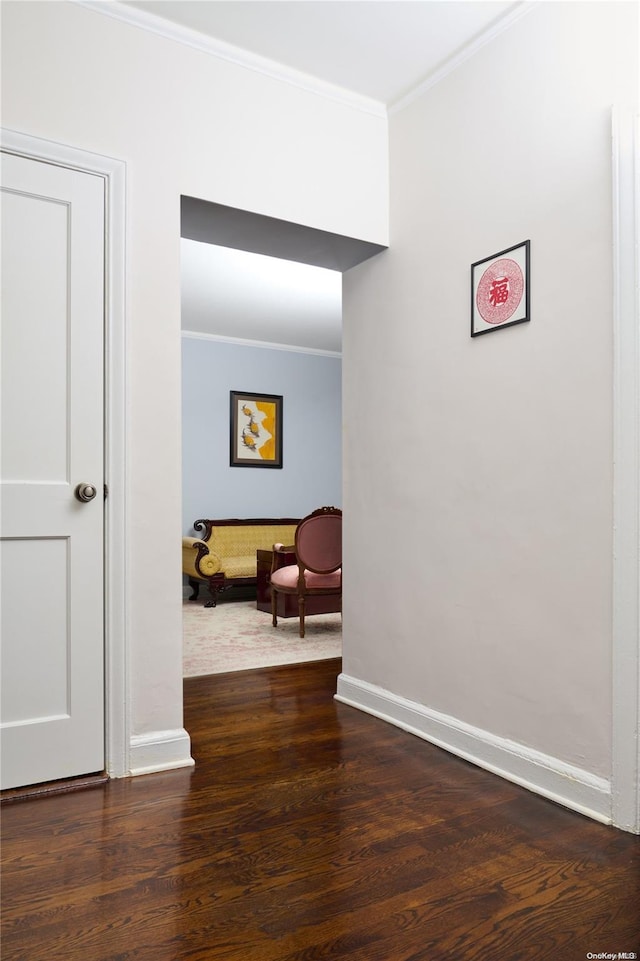 corridor featuring ornamental molding and dark wood-type flooring