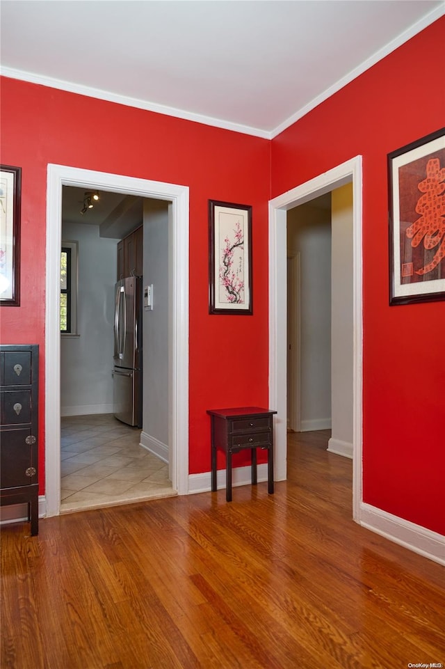 spare room with crown molding and hardwood / wood-style flooring