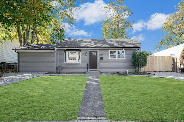 ranch-style home with a front lawn